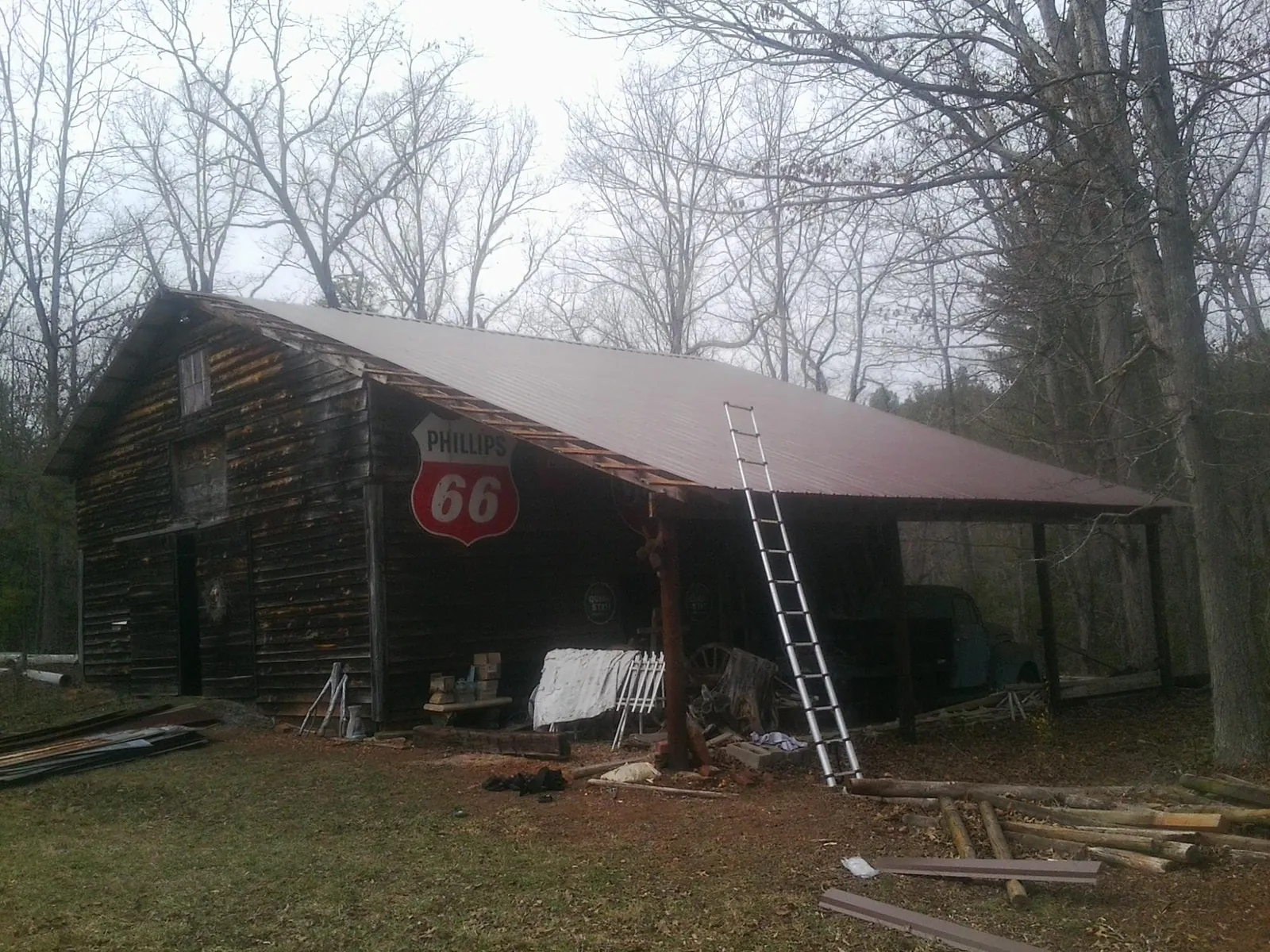 New metal roof on an open sided timber barn with a vintage sign in Union
